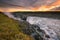 Detifoss waterfall with sunset in the background