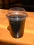 Detox Activated Charcoal Black Lemonade in Transparent Plastic Cup