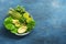Detox Buddha bowl with avocado, asparagus, micro greens, lime, lettuce, basil and mint.Dietary food. Blue rustic background, top v