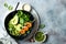 Detox Buddha bowl with avocado, spinach, greens, zucchini noodles, grilled shrimps and pesto sauce.