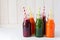 Detox drinks in bottles: fresh smoothies from vegetables: beet, carrot, spinach, cucumber and apple