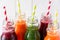 Detox drinks in bottles: fresh smoothies from vegetables: beet, carrot, spinach, cucumber and apple