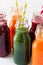 Detox drinks in bottles: fresh smoothies from vegetables: beet, carrot, spinach, cucumber and apple