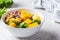 Detox salad with kale, mango and sprouts in white bowl. Vegan food, healthy plant-based diet concept