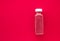 Detox superfood strawberry smoothie bottle for weight loss cleanse on.red background, flatlay design for food and nutrition expert