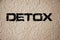 Detox text on grunge light wall. Healthcare concept