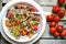 Detox , vegan , raw salad with tomatoes , onions and walnuts