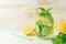 Detox water infused with sliced lemon, cucumber and sprigs of mint