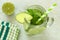 Detox water with lime and cucumbers above view in jar