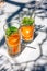 Detox water or orange cocktail with slices of orange and mint in glass with metal recyclable straw. Summertime concept