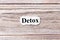 Detox of the word on paper. concept. Words of detox on a wooden background