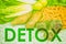 DETOX word title written across uncooked raw vegetables background for eating healthy diet weight loss concept. Green