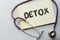 Detox written on a clipboard, Medical concept