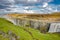 Dettifoss, Iceland. Group of hikers and tourists at the biggest waterfall in Iceland Dettifoss. Birdview of beautiful Icelandic