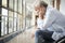 Devastated senior asian man sitting in hospital hallway