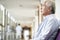 Devastated senior asian man sitting in hospital hallway