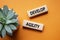 Develop agility symbol. Concept word Develop agility on wooden blocks. Beautiful orange background with succulent plant. Business