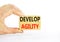 Develop agility symbol. Concept words Develop agility on wooden blocks on a beautiful white table white background. Businessman