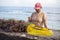 Developing country`s woman sorts out seaweeds from her farming net