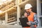 Developing engineer wearing white safety vest and hardhat with w