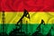 Developing Flag of Bolivia. Silhouette of drilling rigs and oil rigs on a flag background. Oil and gas industry. The concept of
