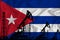 Developing Flag of Cuba. Silhouette of drilling rigs and oil rigs on a flag background. Oil and gas industry. The concept of oil