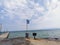 The developing flag of Greece on the background of the Mediterranean Sea. View from the pier to the water