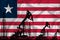 Developing Flag of Liberia. Silhouette of drilling rigs and oil rigs on a flag background. Oil and gas industry. The concept of