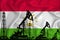 Developing Flag of Tajikistan. Silhouette of drilling rigs and oil rigs on a flag background. Oil and gas industry. The concept of