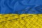 Developing Ukraine Flag, mesh fence and barbed wire. Concept of isolation of emigrants. With place for your text