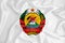 A developing white flag with the coat of arms of Mozambique. Country symbol. Illustration. Original and simple coat of arms in