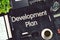 Development Plan - Text on Black Chalkboard. 3D Rendering.
