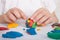 Development of small motor skills of children. A child sculpts a colorful ball of plasticine