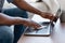 Device Disinfection. Unrecognizable African Guy Sanitizing Laptop Keyboard With Antibacterial Wipes