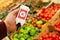device in hand measuring nitrates and pesticides on market vegetables and fruits