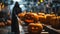 Devil in black cloak work with Pumpkins with halloween scary face on conveyor belt line.