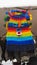 Devil Uma mask woven in blue, red, yellow and green wool hanging in craft store