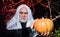 Devil vampire man with pumpkin. Happy Halloween. Evil wizard with Jack-o-lantern.