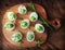 Deviled eggs appetizer with avocado on cutting board