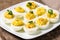 Deviled eggs garnished with parsley and paprika