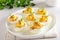 Deviled stuffed eggs with egg yolk, bacon, mustard and dill