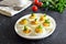 Deviled stuffed eggs with egg yolk, bacon, mustard and parsley