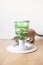 Devon Rex cat plays with smart toy Green color food tree - which stimulates instinct by enticing feline to work for the food.