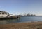 Devonport ferry terminal, sandy beach and coastal cityscape of skyscrapers on harbor shore in Auckland downtown, New Zealand