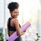 Devote more time to loving yourself. an attractive young woman holding her yoga mat.