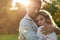 Devoted young couple hugging under the setting sun