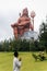 devotee praying to the hindu god lord shiva huge isolated statue at morning