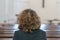 Devout religious woman praying in a church