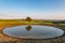 A dew pond on Ditchling Beacon, with evening light