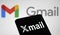 Dhaka, Bangladesh- 27 February 2024: X mail logo displayed on smartphone and Gmail logo on the background